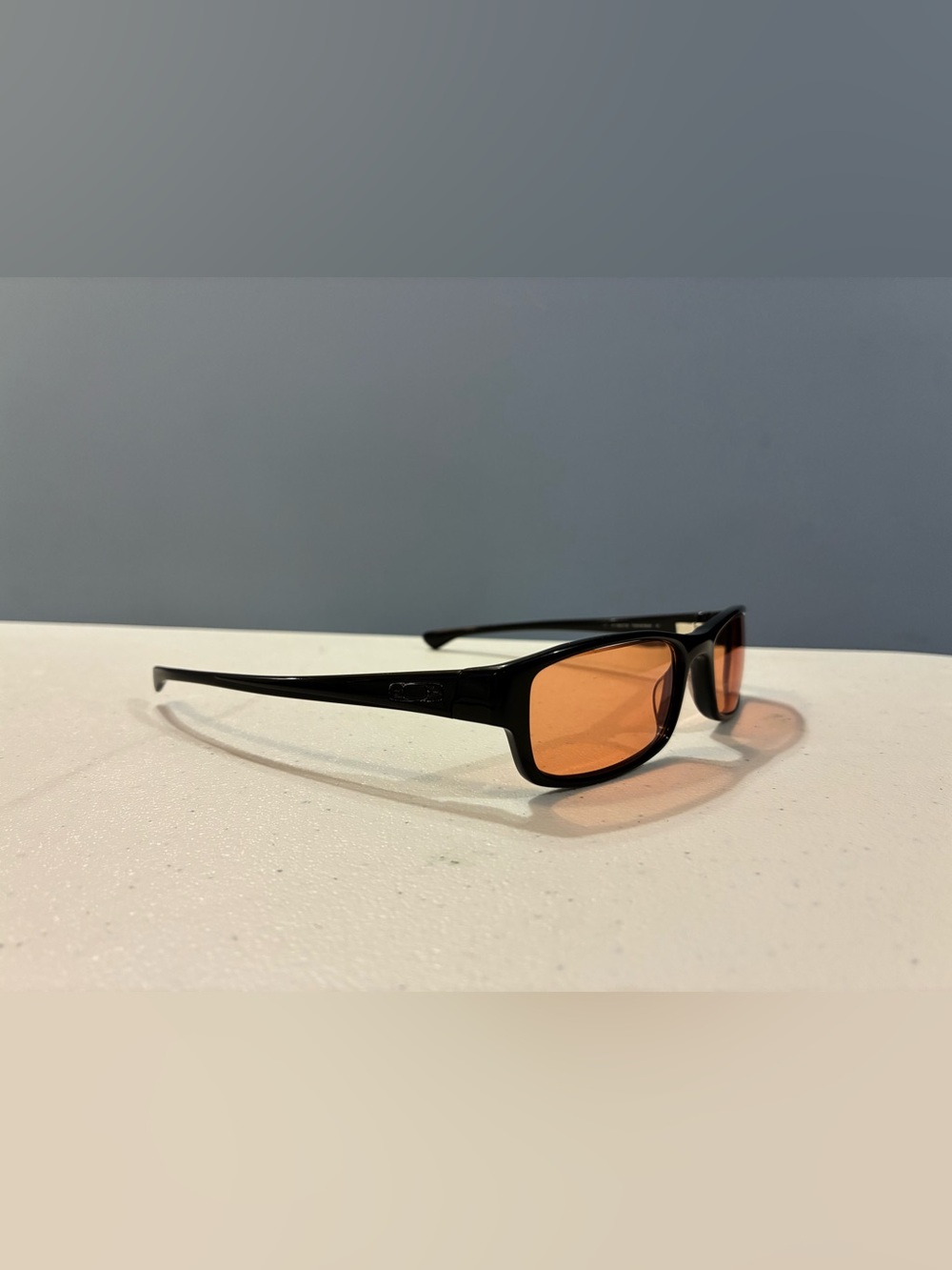 Oakley Black Frame Sunglasses with Orange Lenses